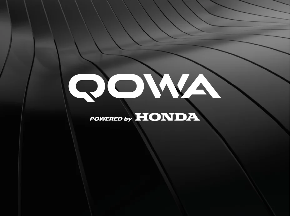 QOWA logo in white with the Powered by Honda lockup, on a sculpted black surface